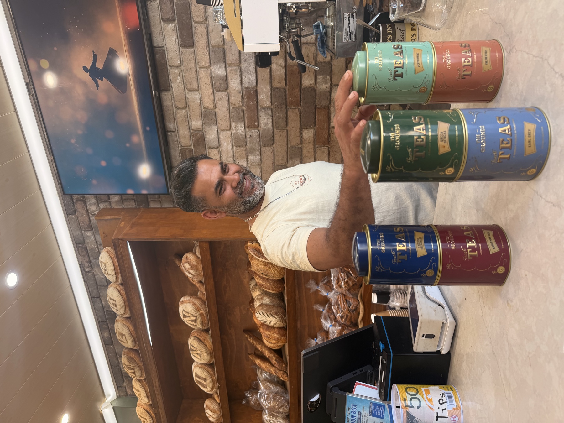 Mohammed smiling behind the counter at Baker’s Inn